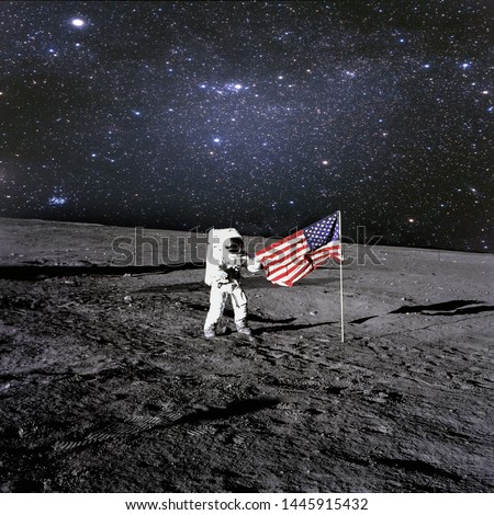 American astronaut landed and set his national flag on the planet. Spaceman explore unknown planet. Outer space. Elements of this image furnished by NASA  Royalty-Free Stock Photo #1445915432