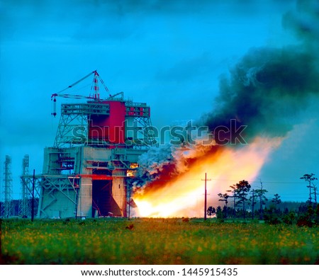 Fire at an industrial building in the late evening. Burning plant. Power substation in fire. Mixed media 