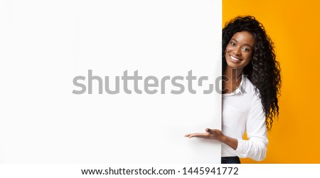 Awesome promo. Smiling african american woman presenting something on white blank board with empty space, panorama Royalty-Free Stock Photo #1445941772
