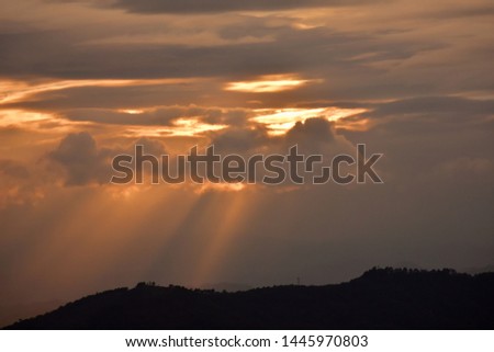 Evening sunset picture.Sunray in the cloud and over the mountain.Chiang Mai.Thailand.