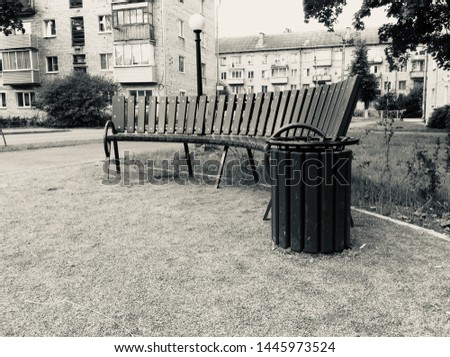 black and white photo of park bench