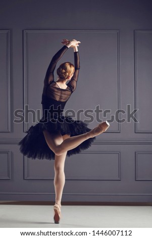 Ballerina ballet dancer over gray background.