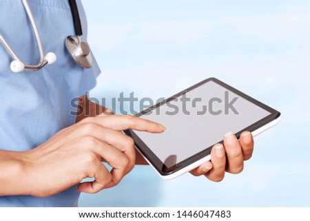 woman doctor holding tablet computer