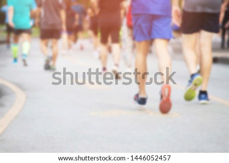blur photo group of people crowd. Athlete runner feet running exercise on race track on the street road close up on shore in park public . fitness jog workout wellness concept.