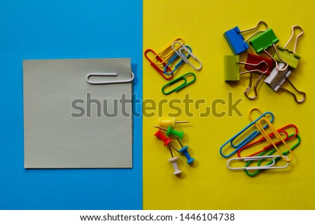 Colored paper and  clips. 
Paper clips. School and office accessories