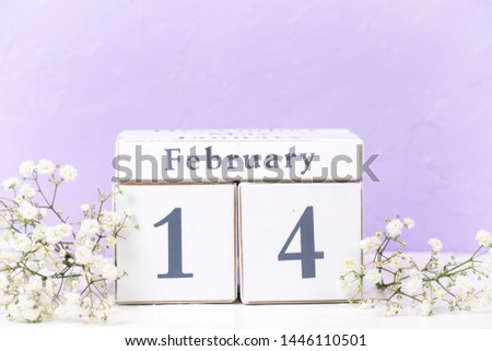 Background with calendar and tender white flowers near by violet textured  wall. Selective focus. Place for text.