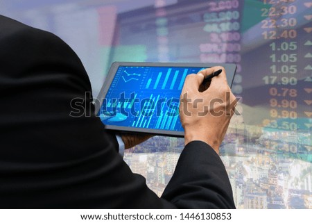 Technology business touch screen tablet stock market graph viewing
