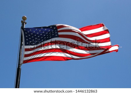 American flag waving on a sunny day