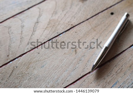 Close-up of the pen on an old wooden table selective focus and shallow depth of field