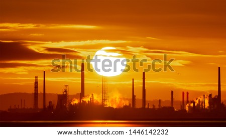 Global Warming Climate Change Concept
Epic sunrise at Stanlow Oil Refinery and power plant on the Mersey Estuary Wirral. Greenhouse gas emissions and pollution warm the planet on an industrial dawn.  Royalty-Free Stock Photo #1446142232