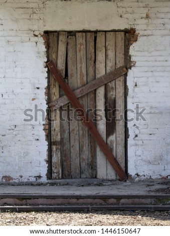 Old wooden locked door. Old damaged wooden locked door. 