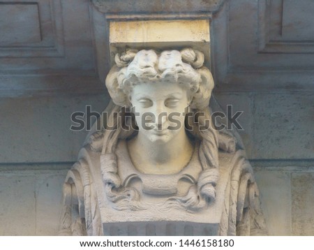 Beautiful facade of building in the French Bordeaux city at sunny summer day time. Sculpture woman head decorate it. High resolution photo.