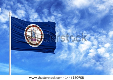 National flag State of Virginia on a flagpole in front of blue sky