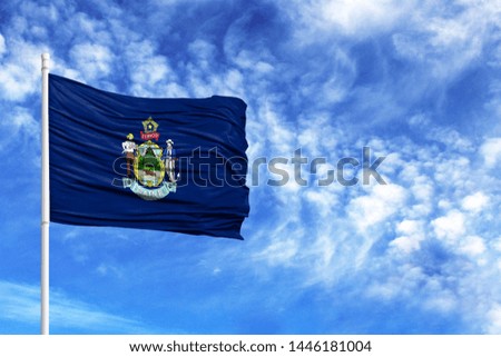National flag State of Maine on a flagpole in front of blue sky