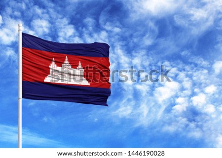National flag of Cambodia on a flagpole in front of blue sky