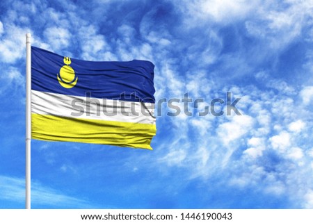 National flag of Buryatia on a flagpole in front of blue sky