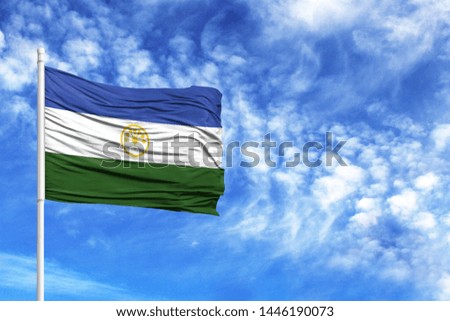 National flag of Bashkortostan on a flagpole in front of blue sky