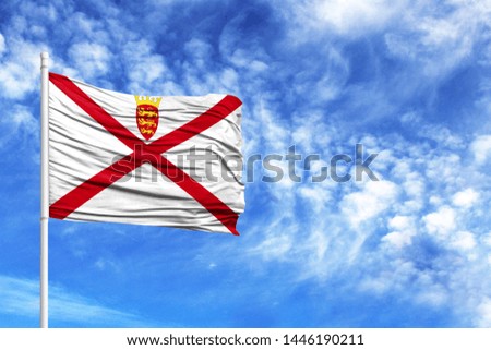 National flag of Jersey on a flagpole in front of blue sky