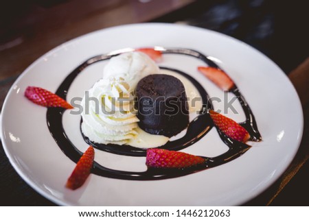 The picture of hot chocolate lava cake with vanilla ice cream and fresh strawberry