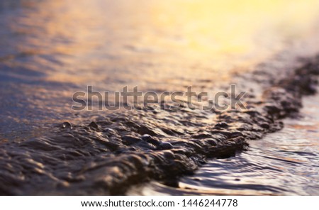 Close-up photos of water waves in the evening