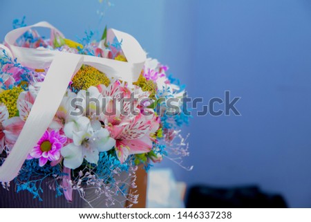 Bouquet of fresh Pink, white , blue, orange roses  . Bouquet of multicolored roses . Pink flower picture close up in the bouquet. Ribbon