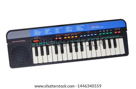 Electric piano keyboard for small kids isolated on the white background. With clipping path. Children plastic toy in the shape of musical instrument with colourful buttons. With vector path.  Royalty-Free Stock Photo #1446340559
