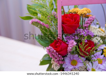 Pink bouquet of fresh purple, red, Pink, white , blue, orange roses  . Pink bouquet of multicolored roses . Red , purple flower picture close up in the bouquet. Ribbon 