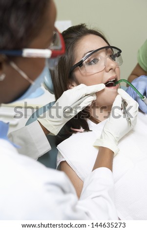 Closeup of dentists examining a patient's teeth in the dental clinic