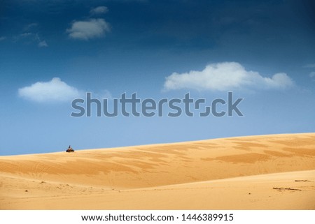 Yellow buggy in sand dune for copy space.