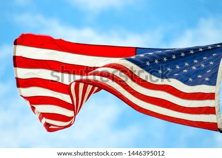 the stars and stripes waving in the wind
