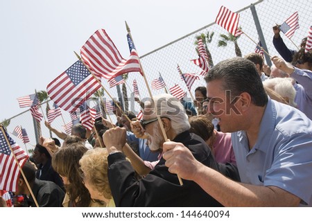 Diverse group of people with American flag during a rally