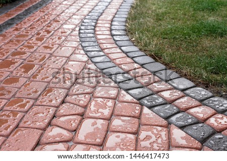 impregnated paving stones on the path not receiving rainwater Royalty-Free Stock Photo #1446417473