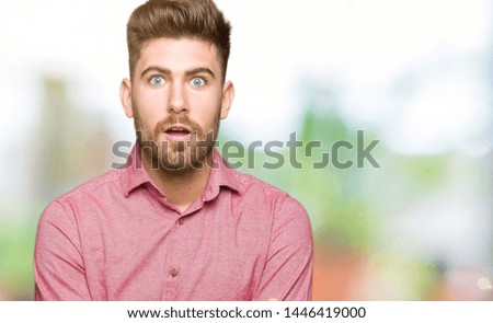 Young handsome business casual man afraid and shocked with surprise expression, fear and excited face.