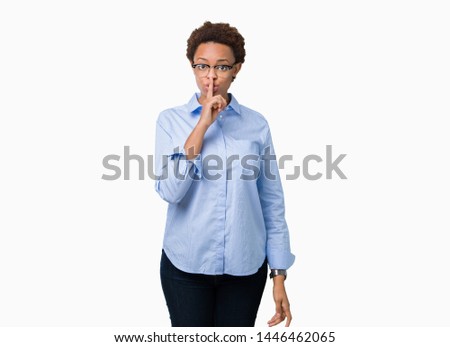 Young beautiful african american business woman over isolated background asking to be quiet with finger on lips. Silence and secret concept.