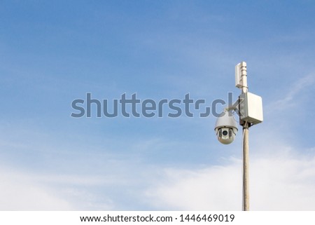 Security Camera on a blue sky background. Surveillance camera for guarding territory. Security of private property.