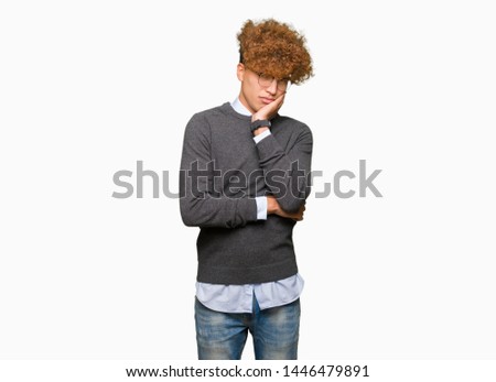 Young handsome business man with afro hair wearing glasses thinking looking tired and bored with depression problems with crossed arms.