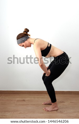 Woman doing abdominal hypopressives indoor Royalty-Free Stock Photo #1446546206