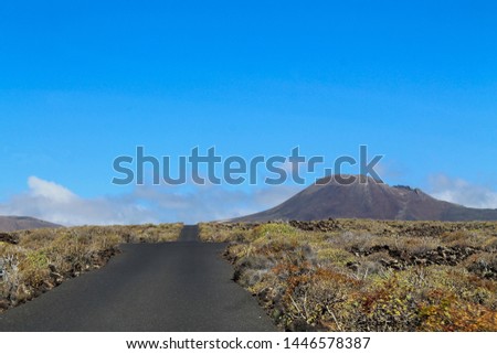 Lonely road with mountain in background - Lanzarote