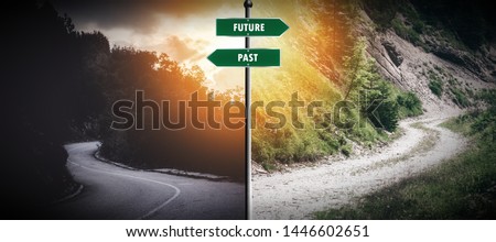 Two way junction with "past and present" sign in the middle. Meant to symbolize moving on and not looking a the past Royalty-Free Stock Photo #1446602651