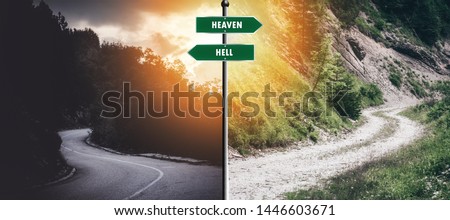 two way junction road with a sign that says "heaven and hell" its meant to represent different easy or hard choices we make in our life Royalty-Free Stock Photo #1446603671