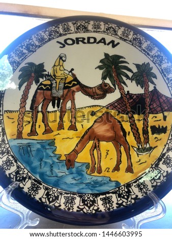 Jordan, Petra. Souvenirs in a store in Petra. Decorative plate with camels and palm trees.