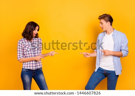 Close up photo of pair standing opposite he him his she her lady boy hands show to empty space on low little tiny prizes wear casual denim jeans plaid shirts outfit isolated on yellow background