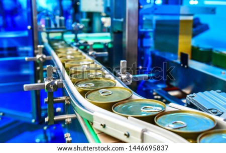Canned food products on conveyor belt in distribution warehouse.parcels transportation system concept. Royalty-Free Stock Photo #1446695837