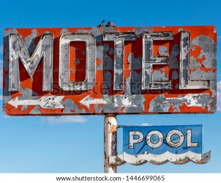A dilapidated, vintage motel sign in the desert of Arizona