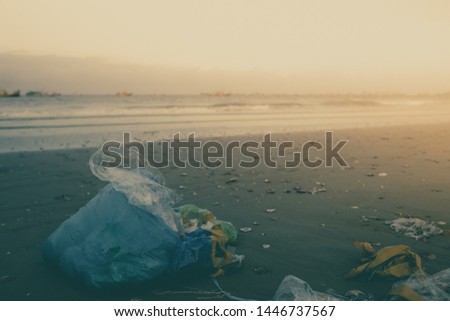Trash, plastic, garbage, bottle... environmental pollution on sandy beach. Royalty high-quality stock photo image of trash, plastic bag, bottle on the beach. Waste that polluted the ocean environment