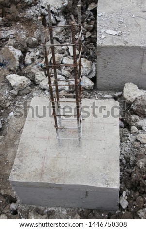 Concrete building construction site. Concrete slab of building foundation. Foundation pit with concrete piles reinforcement.  Steel rebar of concrete piles, foundation slab.