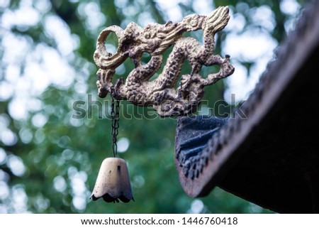 Dragons and brass bells on eaves