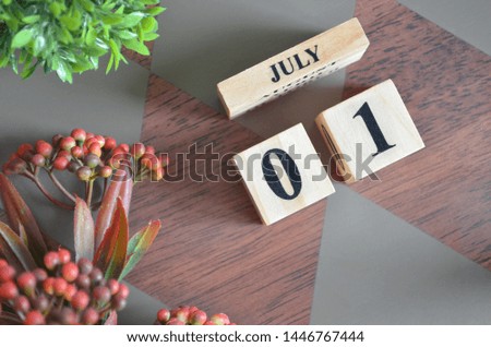 July 1. Date of July month. Diamond wood table for background.