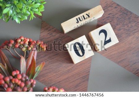 July 2. Date of July month. Diamond wood table for background.