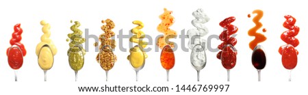 Set of spoons with different delicious sauces on white background, top view Royalty-Free Stock Photo #1446769997